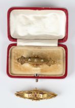 A late Victorian 15ct gold and diamond three stone brooch with applied bead and ropetwist