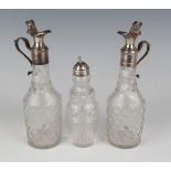 A pair of mid-18th century silver mounted cut glass oil and vinegar bottles, each facet cut body