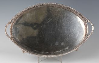 A late Victorian silver oval two-handled tray with pierced scroll gallery and beaded rim, on