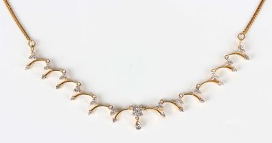 A gold and diamond necklace, the front with a seven stone diamond cluster above a single stone