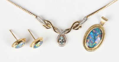 A gold mounted oval opal doublet pendant, detailed ‘18K’, length 2.7cm, a pair of gold mounted