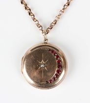 A gold back and front, half-pearl and red gem set circular pendant locket with a crescent and star