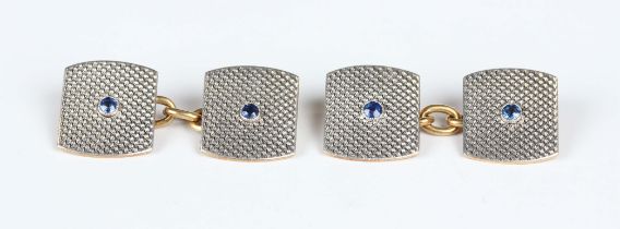 A pair of gold, platinum and sapphire cufflinks, each of curved rectangular form, centred by a