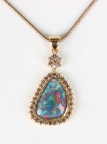 A gold, opal triplet and tinted brown diamond drop shaped pendant, unmarked, weight 12.5g, length