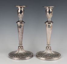 A pair of Elizabeth II silver candlesticks, each oval urn shaped sconce with detachable nozzle above