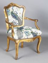 An 18th century French Rococo giltwood open armchair, later upholstered in peacock decorated fabric,