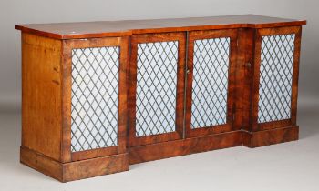 A 19th century mahogany inverted breakfront side cabinet, the four doors inset with blue silk and