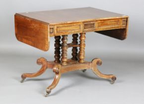 A Regency mahogany sofa table, the crossbanded top above two drawers, raised on four downswept legs,