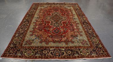 A Tabriz carpet, Central Persia, mid/late 20th century, the red field with a shaped medallion,