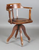 An early/mid-20th century oak framed tub back revolving desk chair, height 80cm, width 58cm.Buyer’