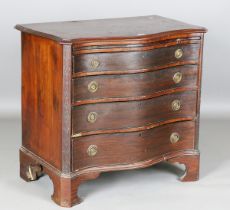 A late 19th century George III style mahogany serpentine fronted chest of drawers, fitted with a