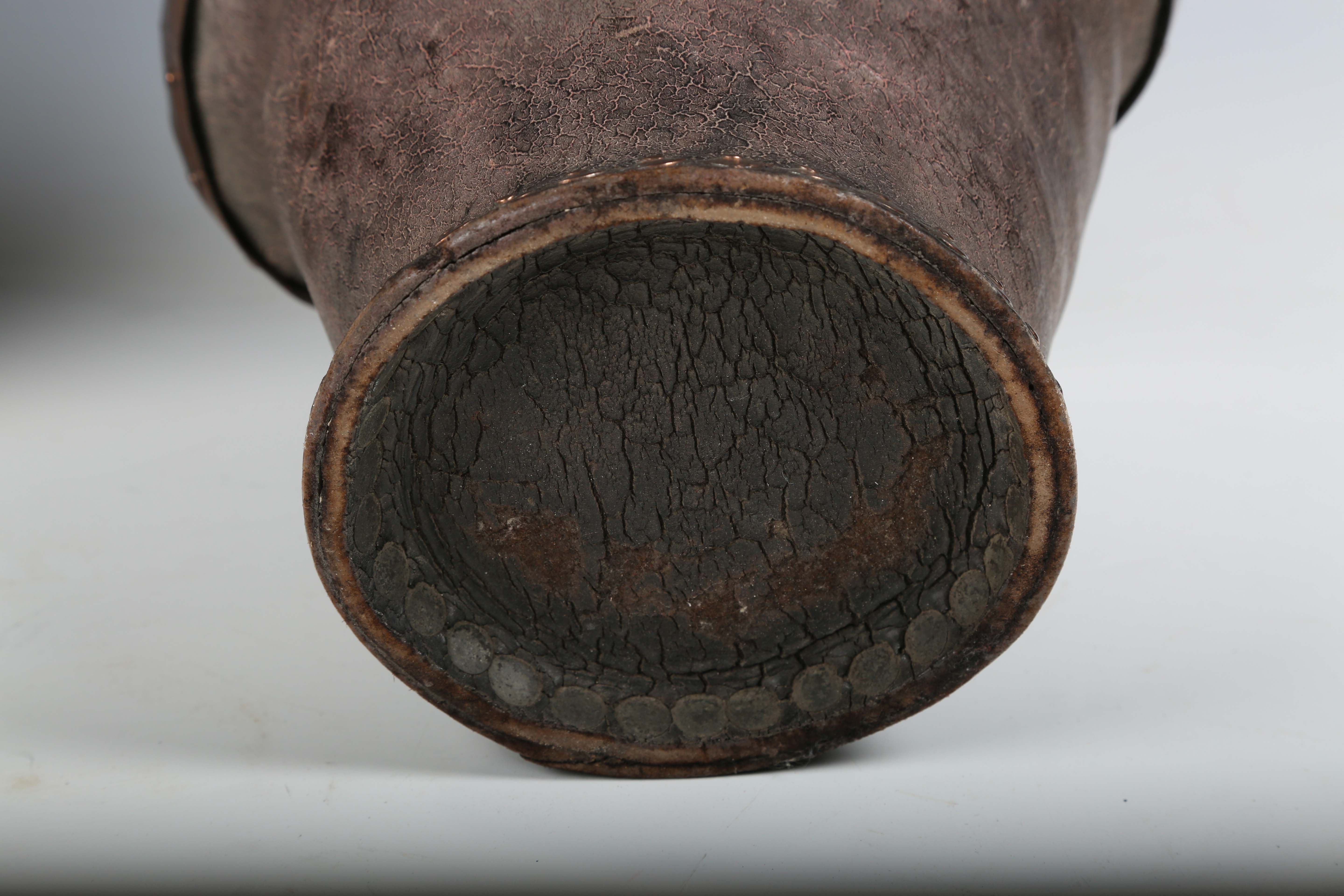 Two 18th century leather fire buckets with applied metal rims, heights