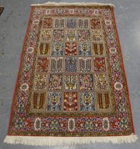 A Persian garden design rug, mid-20th century, the compartmentalized field within a palmette border,