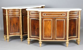 A pair of 20th century Regency style marble-topped and giltwood side cabinets, each shaped Cararra