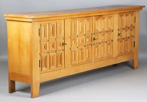 A late 20th century Continental oak side cabinet, the four panelled doors enclosing shelves and