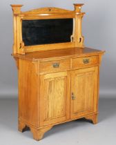 An Edwardian Arts and Crafts oak mirrored-back side cabinet, height 145cm, width 106cm, depth 43.