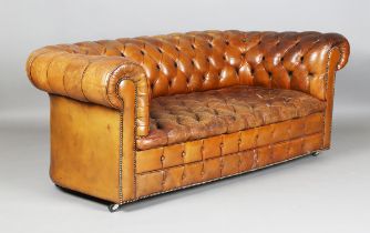 A 20th century buttoned brown leather Chesterfield settee with brass studded borders, height 74cm,