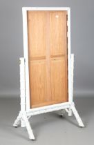 A 19th century white painted faux bamboo cheval mirror, raised on thick angular supports, height