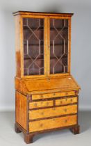 An 18th century pollard birch bureau bookcase with overall crossbanded borders and ebony