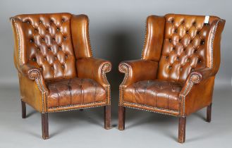 A pair of 20th century George III style buttoned brown leather wing back armchairs, height 96cm,