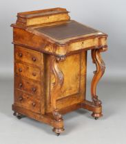 A mid-Victorian walnut Davenport with a maple-lined interior and carved cabriole supports, height