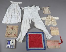 A mixed group of textiles, including a selection of 19th century lacework, a black silk cape, two