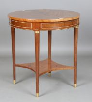 A late 19th century French figured mahogany circular two-tier table with applied gilt metal mounts