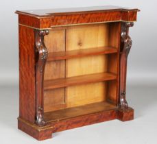 A 19th century and later mahogany open bookcase, the inverted breakfront flanked by carved supports,