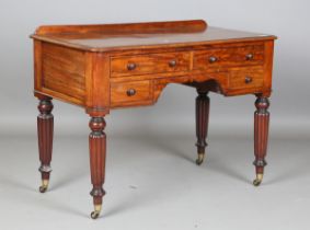 An early Victorian mahogany kneehole side table, fitted with an arrangement of four drawers, on