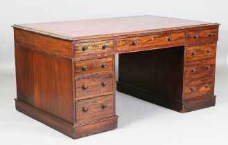 A late Victorian mahogany twin-pedestal partners desk, the moulded top inset with claret leather