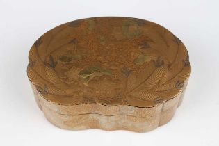 A Japanese gilt lacquer box and cover, Meiji period, of shaped oval form, the top decorated with