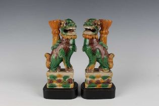 A pair of Chinese sancai enamelled biscuit porcelain Buddhistic lion jostick holders, each