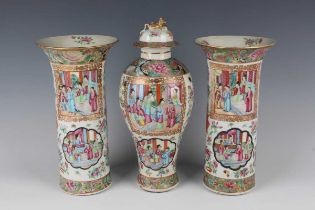 A garniture of three Chinese Canton famille rose porcelain vases, mid-19th century, comprising a