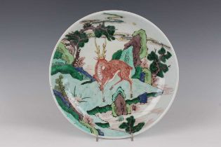 A Chinese famille verte porcelain saucer dish, Kangxi style but later, painted with a deer
