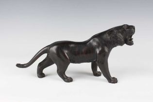 A Japanese cast bronze model of a tiger, Meiji/Taisho period, modelled standing with patinated