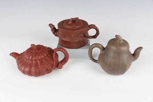 A group of three Chinese Yixing stoneware teapots and covers, comprising one of cylindrical bamboo