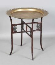 A Chinese brass and hardwood tray-top table, early 20th century, the brass circular tray engraved