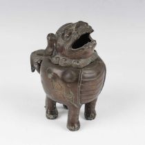 A Chinese bronze Buddhistic lion censer, late Qing dynasty, the pierced head forming the hinged