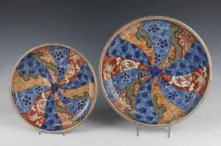 A graduated pair of Japanese Imari porcelain circular saucer dishes, Meiji period, each interior