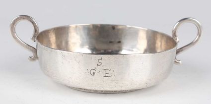 A South American white metal shallow bowl, the front engraved with the letter 'S' above 'G.E',