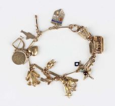 A 9ct gold bar link charm bracelet on a boltring clasp, fitted with five 9ct gold charms, four