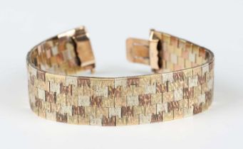 A 9ct three colour gold bracelet in a wide multiple row design with a textured finish, on a snap