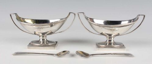 A pair of George III silver oval two-handled salts, each with reeded rim above engraved crest, on an