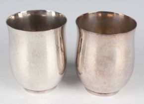 A pair of Elizabeth II silver beakers, each of slightly tapered cylindrical form with hammered