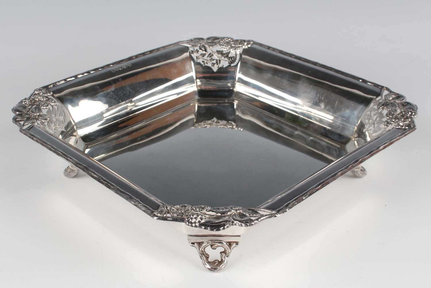 An Edward VIII silver square dish, each canted corner pierced and cast with stems of fruiting and