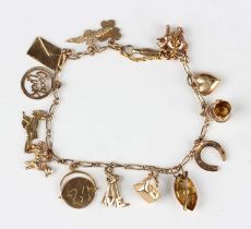 A gold twisted oval and curblink charm bracelet, detailed ‘9ct’, fitted with twelve gold charms,