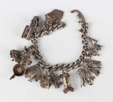 A silver curblink charm bracelet, fitted with a variety of mostly silver charms, including a