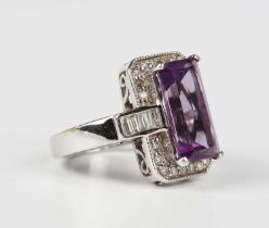 A white gold, amethyst and diamond ring, claw set with the rectangular cut amethyst within a