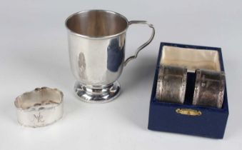 A pair of George VI silver napkin rings with cast Celtic style rims, London 1939 by Goldsmiths &