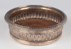 A George III silver circular half-reeded wine coaster, Sheffield 1819 by John & Thomas Settle,